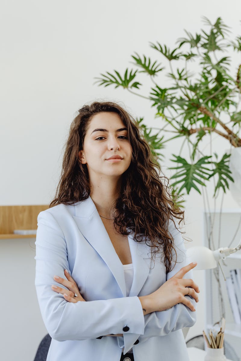 A Woman in White Blazer Looking with Her Arms Crossed